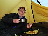 02 Jerome Ryan Enjoying Afternoon Tea And Cookies At Kharka On Way To Mesokanto La The trail climbs up the valley from Thini, keeping to the left and away from the Nepalese army in the restricted military area. We stayed the night at a kharka at 3460m. Jerome Ryan enjoyed afternoon tea and cookies in his tent.